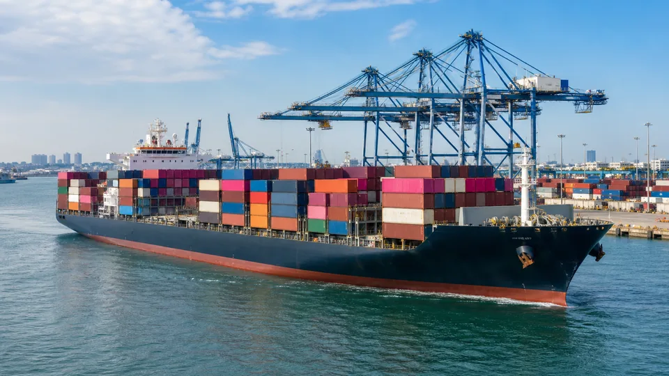 Container cargo ship entering a commercial port
